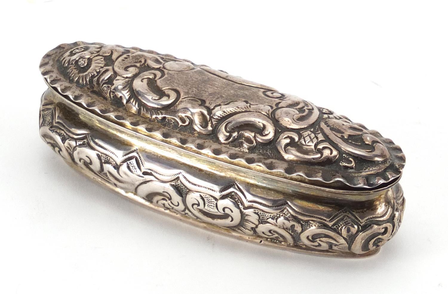 Victorian oval silver box, with embossed decoration and hinged lid, indistinct markers mark