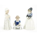 Three Royal Copenhagen figurines including one of a young girl reading a book and one of a young