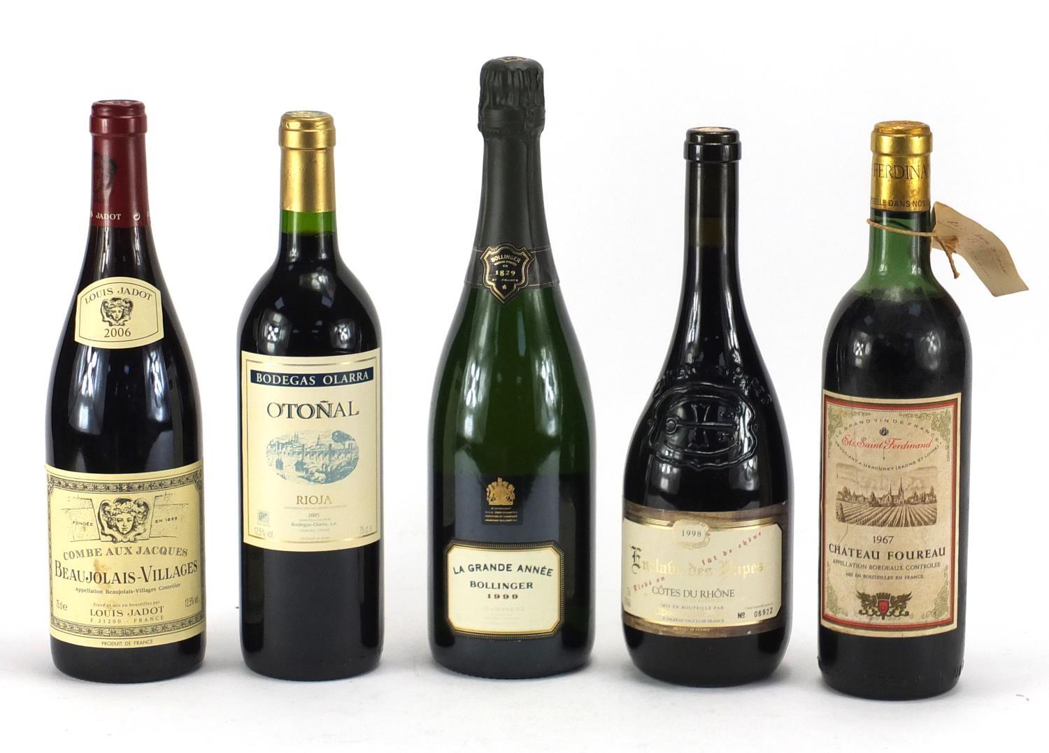 Four bottles of alcohol including a bottle of La Grande Année Bollinger 1999 and Chateau Foureau