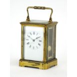 19th century brass cased carriage clock striking on a gong, with enamelled dial and Roman