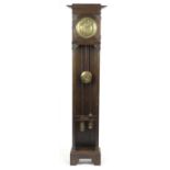 Arts & Crafts carved oak eight day long case clock striking on a gong, the brass face with Arabic