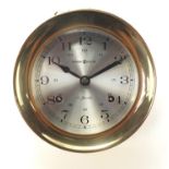 Howard Miller brass bulk head clock striking on a bell with Arabic numerals, 13.5cm in diameter :