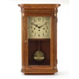 Howard Miller oak cased wall clock with Westminster chime, the dial with Arabic numerals, 61cm