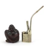 Chinese carved wooden Buddha and a silver coloured metal opium pipe, engraved with bird of