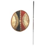 Tribal interest Maasai shield and spear, the shield hand painted with a geometric decoration, the