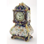 French Quimper pottery mantel clock, decorated with stylised flowers, the enamelled dial with Arabic