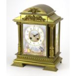 French brass mantel clock with enamelled panels, hand painted with figures and buildings, the
