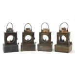 Four Welch patent railway lamps, three with ceramic burners, each with various plaques including a