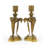 Pair of 19th century gilt bronze ram design candlesticks raised on triangular bases, 18cm high : For