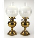 Pair of brass oil lamps with glass funnels and etched globular shades, each 51cm high : For