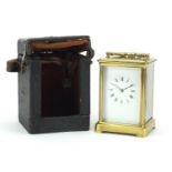 Large brass cased carriage clock with enamelled dial, roman numerals and travelling case, 13.5cm