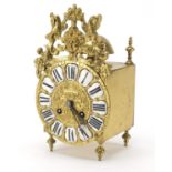 17th style ornate brass lantern mantel clock striking on a bell, with enamelled Roman numerals,