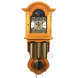 German pine eight day wall clock by Kieninger, chimining on five rods, with moon phase dial, 82cm