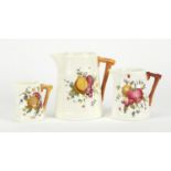 Graduated set of three Royal Worcester naturalistic jugs, hand painted with fruits, each with