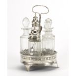 Georgian silver five bottle cruet stand with five glass bottles, two with silver lids, the stand