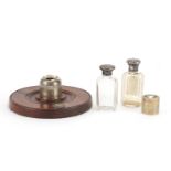 Silver items comprising inkwell on mahogany base, two cut glass scent bottles and a cylindrical