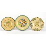 Two Ashtead pottery plates including one hand painted with stylised foliage, each with factory marks