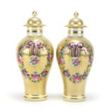 Pair of 19th century style baluster vases and covers, each hand painted and gilded with ribbons