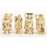 Four Japanese carved ivory Okimono's including one of a fisherman, one with character marks to the