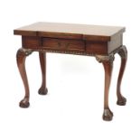 Reproduction mahogany games table, the opening top with chess and backgammon board on carved