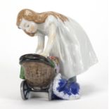 19th century Meissen porcelain figure of a young girl playing with her doll, blue cross sword