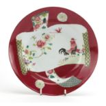 Chinese porcelain red ground shallow dish, hand painted in the famille rose palette with a cockerel,