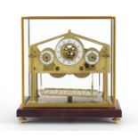 Brass Congreve style Rolling Ball Clock clock with three enameled dials, housed under a glass dome