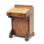 Victorian inlaid walnut davenport, the lift lid with tooled leather insert above a panel door,