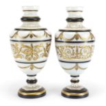 Matched pair of 19th century white opaline glass vases gilded with foliate motifs, each 29.5cm