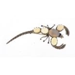 Unmarked silver and opal scorpion brooch with sapphire eyes, 7cm in length, approximate weight 8.