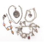 Silver and white metal jewellery including a large oval locket, charm bracelet and opalescent