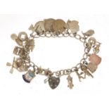 Silver charm bracelet with a selection of mostly silver charms including Singer sewing machine,