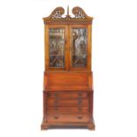 Mahogany bureau bookcase with a pair of astragal glazed doors, above a fall and four drawers on