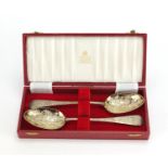 Pair of Victorian silver serving spoons engraved with flowers and gilt bowls, by George Whiting