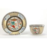 Chinese porcelain armorial tea bowl and saucer hand painted with crests and flowers, the tea bowl