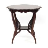 Edwardian mahogany occasional table with shaped top and under tier, 67cm high x 68cm in diameter :