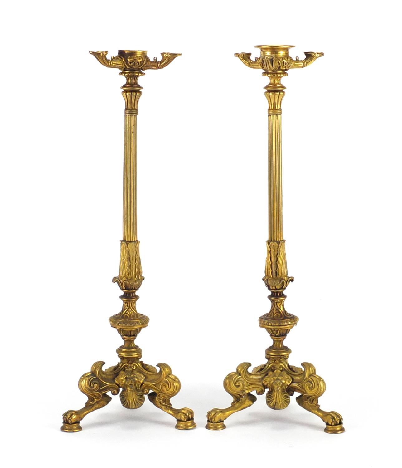 Pair of 19th century ormolu candlesticks with reeded columns, lion masks and claw feet, each 34.