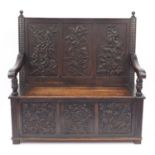 Oak Settle with floral carved panels and lift up seat, 122cm H x 123cm W x 46cm D : For Further
