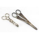 Pair of Victorian silver grape scissors and a pair of silver sugar nips, London 1893 and 1914, the