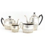 Victorian silver four piece tea set with demi fluted body and engraved with flowers, by Walter &