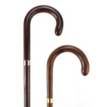 Two walking sticks, one with 9ct gold collar the other with 18ct gold plated collar, the largest