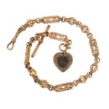 Victorian 9ct rose gold watch chain with gilt metal love heart locket, the chain 30cm in length,