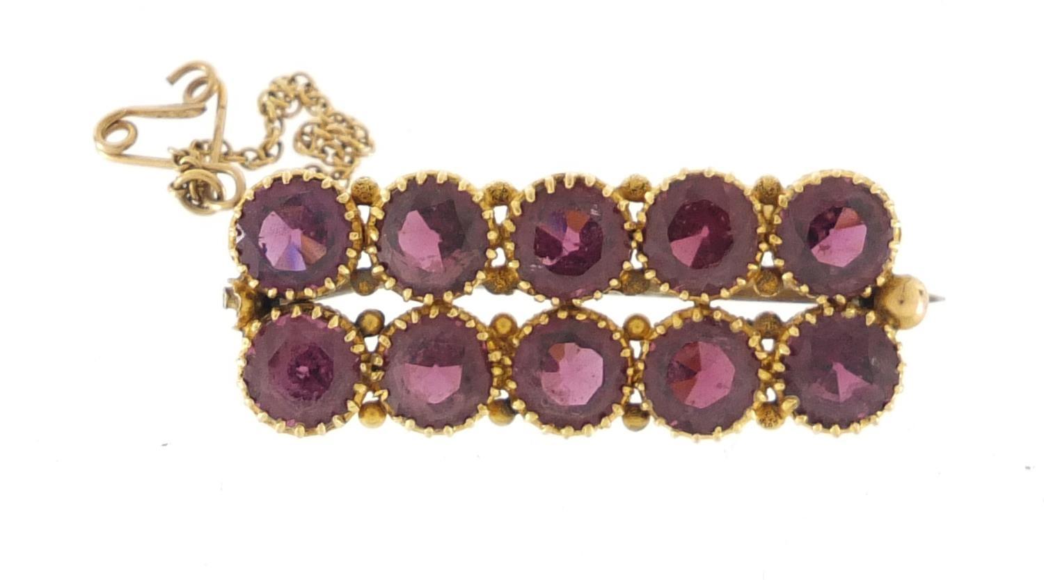 Unmarked gold amethyst bar brooch, 3.6cm in length, approximate weight 8.1g : For Further