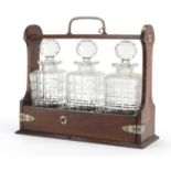 Oak three bottle tantalus with silver plated mounts, 31.5cm high : For Further Condition Reports and