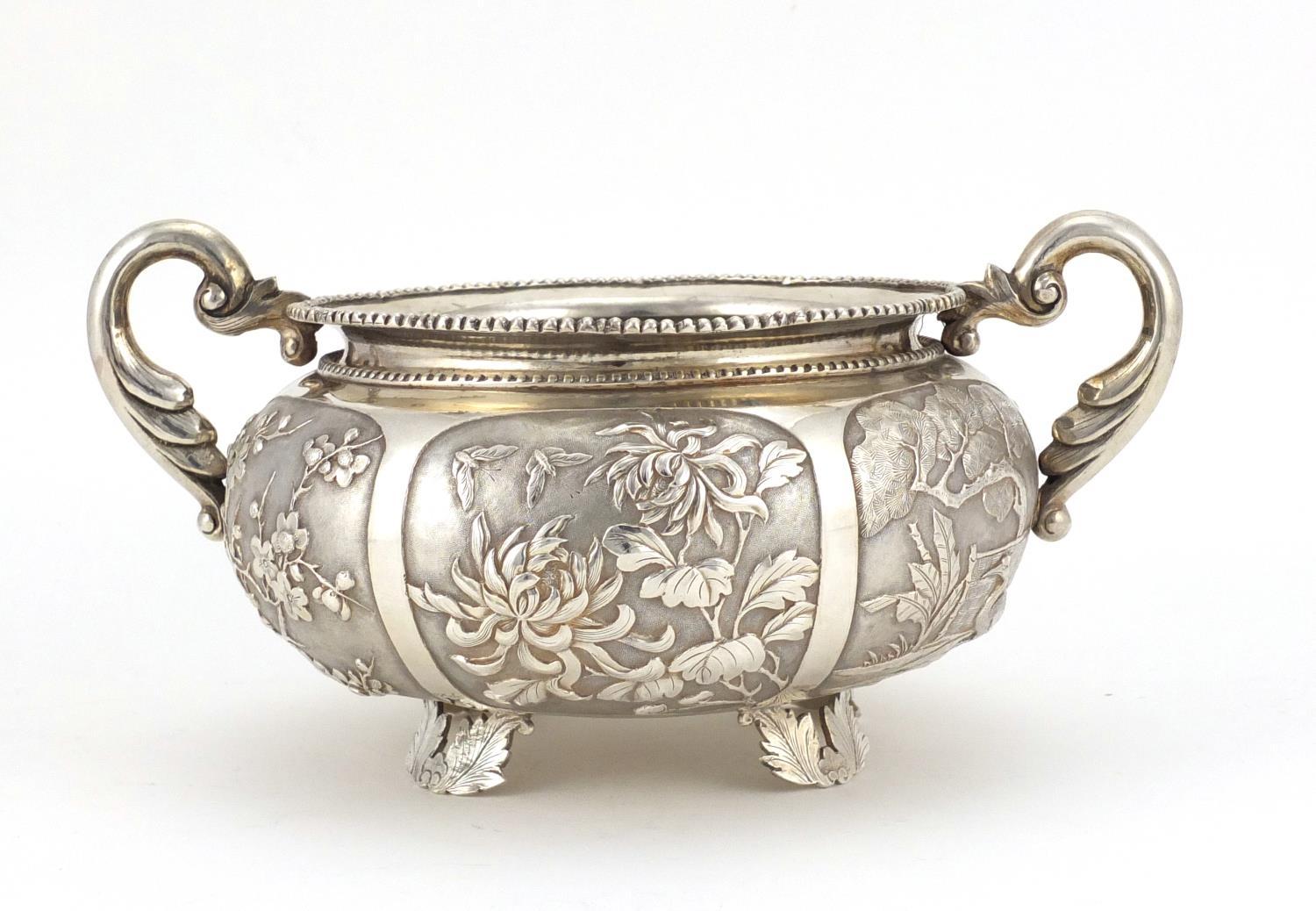 Chinese silver twin handled bowl embossed with dragons, birds, insects and flowers, impressed W A to