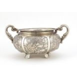 Chinese silver twin handled bowl embossed with dragons, birds, insects and flowers, impressed W A to