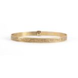 9ct gold adjustable bangle with engraved decoration, Birmingham 1973, approximate weight 8.6g :