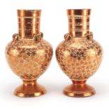 Pair of Middle Eastern lustre vases with four handles, each decorated with floral motifs, each