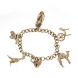 Silver charm bracelet with a selection of silver charms including camel, spinning wheel and