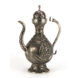 Indian silver coloured metal water jug cast with stylised flowers, 35.5cm high, approximate weight